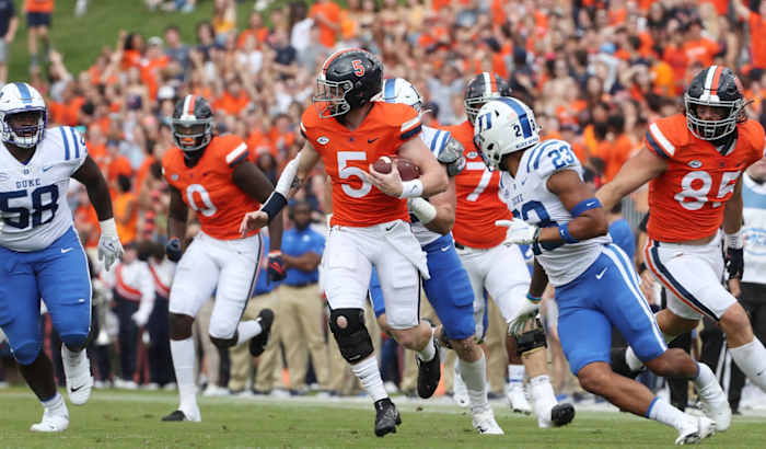 Virginia Cavaliers quarterback Brennan Armstrong runs with the ball against the Duke Blue Devils in 2021.